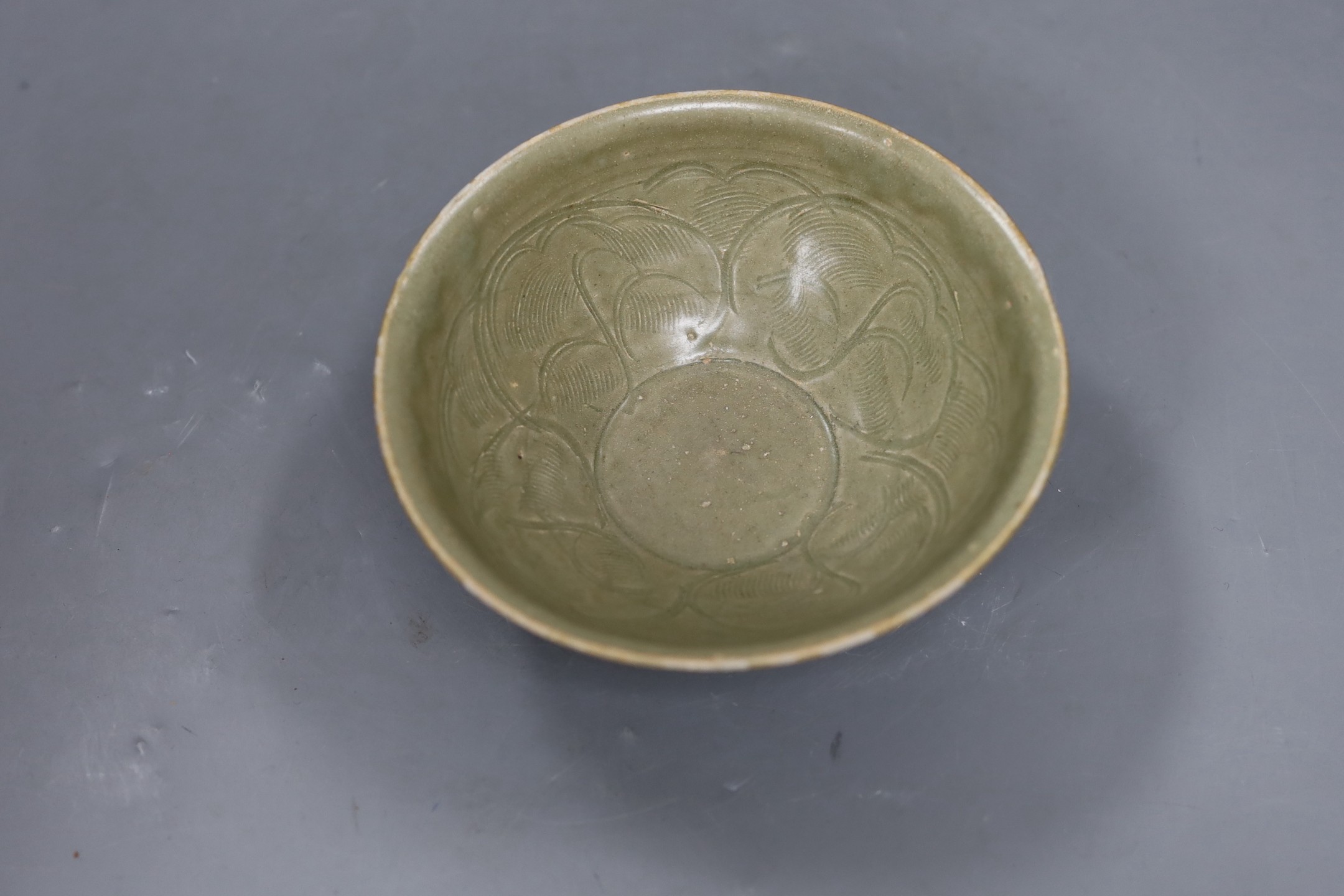 A Chinese carved Yaozhou celadon bowl, Northern Song Dynasty, 15.5cms high